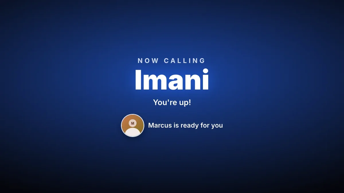 A waiting room TV in the You are up call-up: Now calling Imani, You are up, and Marcus is ready for you beside Marcus’s photo, on a blue screen.